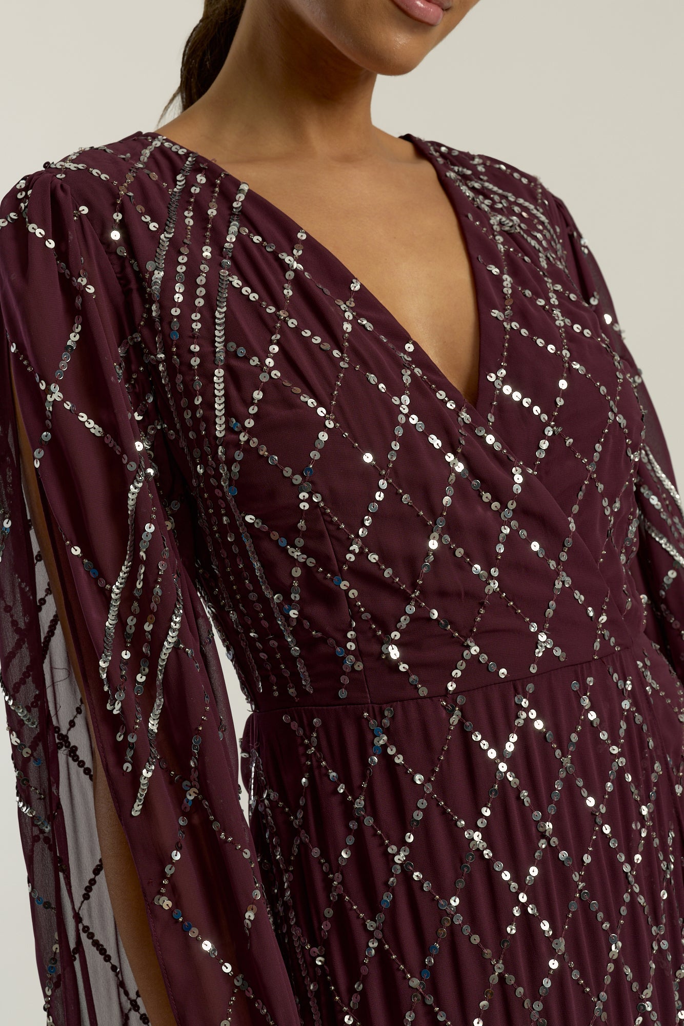 Simone fig sequin cape sleeve maxi dress with plunging V neckline, silver criss-cross sequin detailing and flowing full-length silhouette for statement occasion wear styling