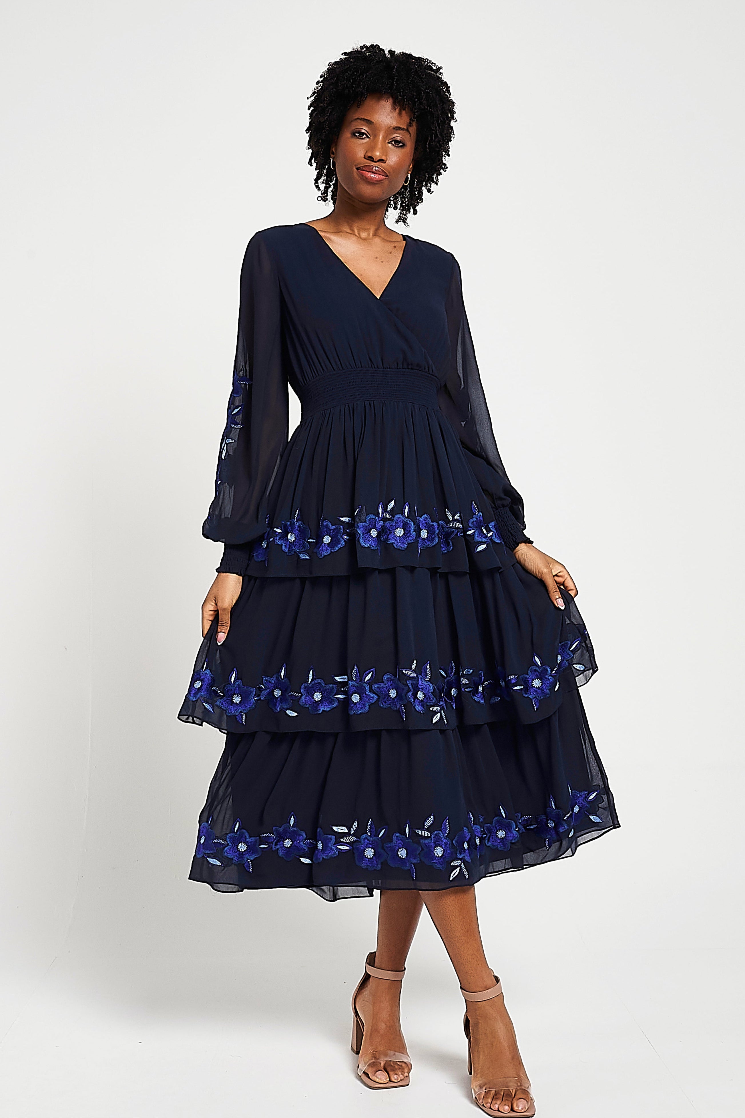 Frock & Frill Tamsin navy floral embroidered midi dress with tiered chiffon skirt, sheer long sleeves, and vibrant blue embroidered detailing—perfect for weddings and special occasions.