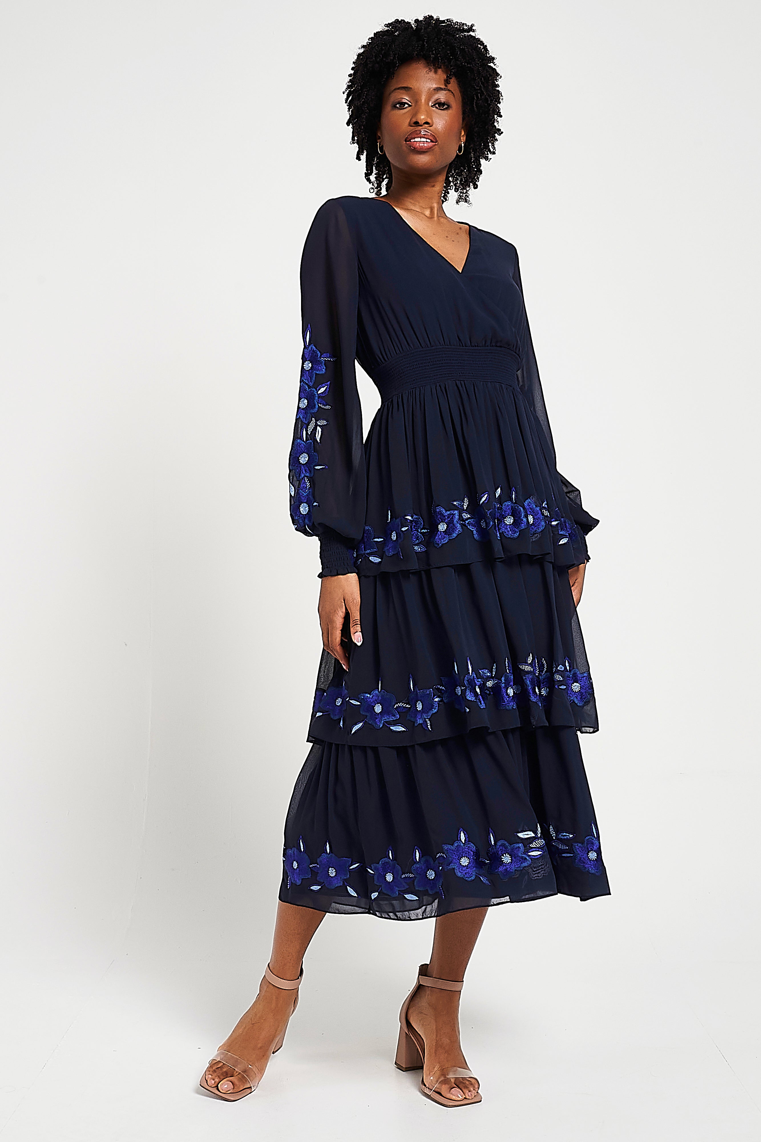 Frock & Frill Tamsin navy floral embroidered midi dress with tiered chiffon skirt, sheer long sleeves, and vibrant blue embroidered detailing—perfect for weddings and special occasions.