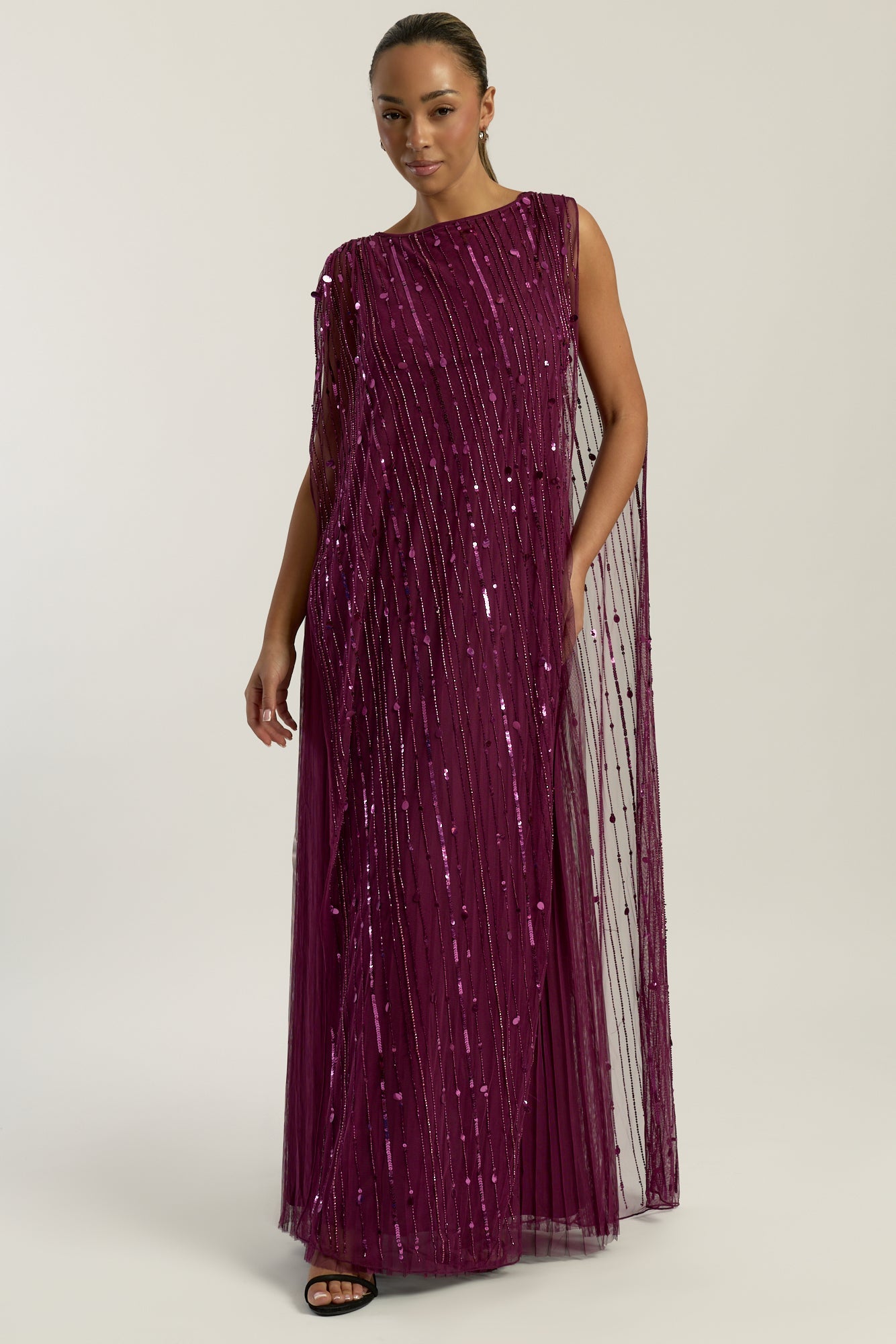 Valencia embellished maxi dress with sheer mesh overlay, intricate tonal beadwork and flowing pleated skirt, elegant beaded evening gown for weddings and formal occasions.