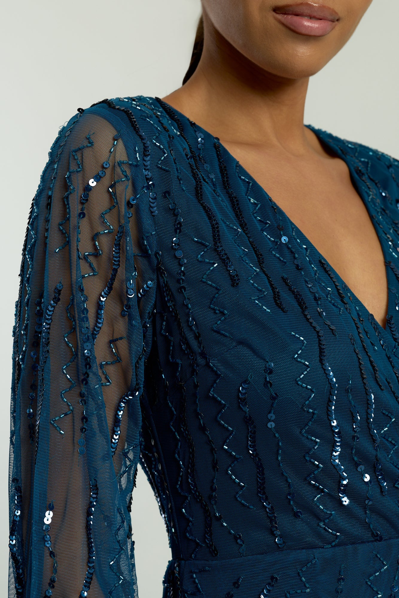 Velora skipper blue sequin midi dress with V-neckline, long sleeves, and fit-and-flare silhouette, perfect for evening events, weddings, and parties.